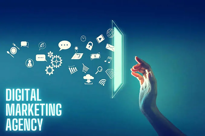 A hand reaching toward a glowing screen as marketing icons float out of it, with the words Digital Marketing Agency